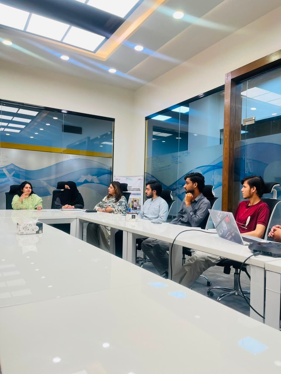 Participants seated around the table in discussion