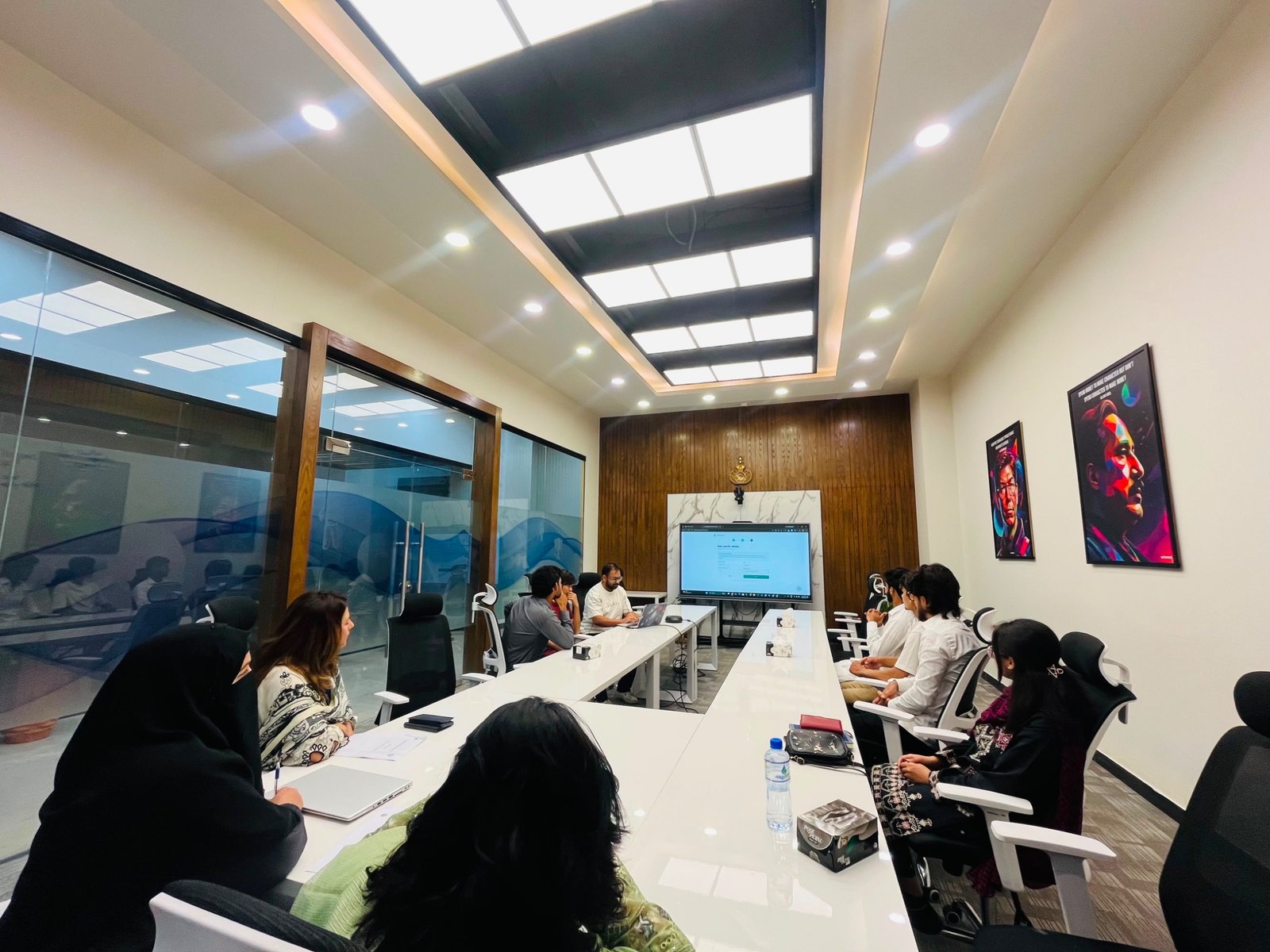 A wide view of participants around the meeting table during the ceremony