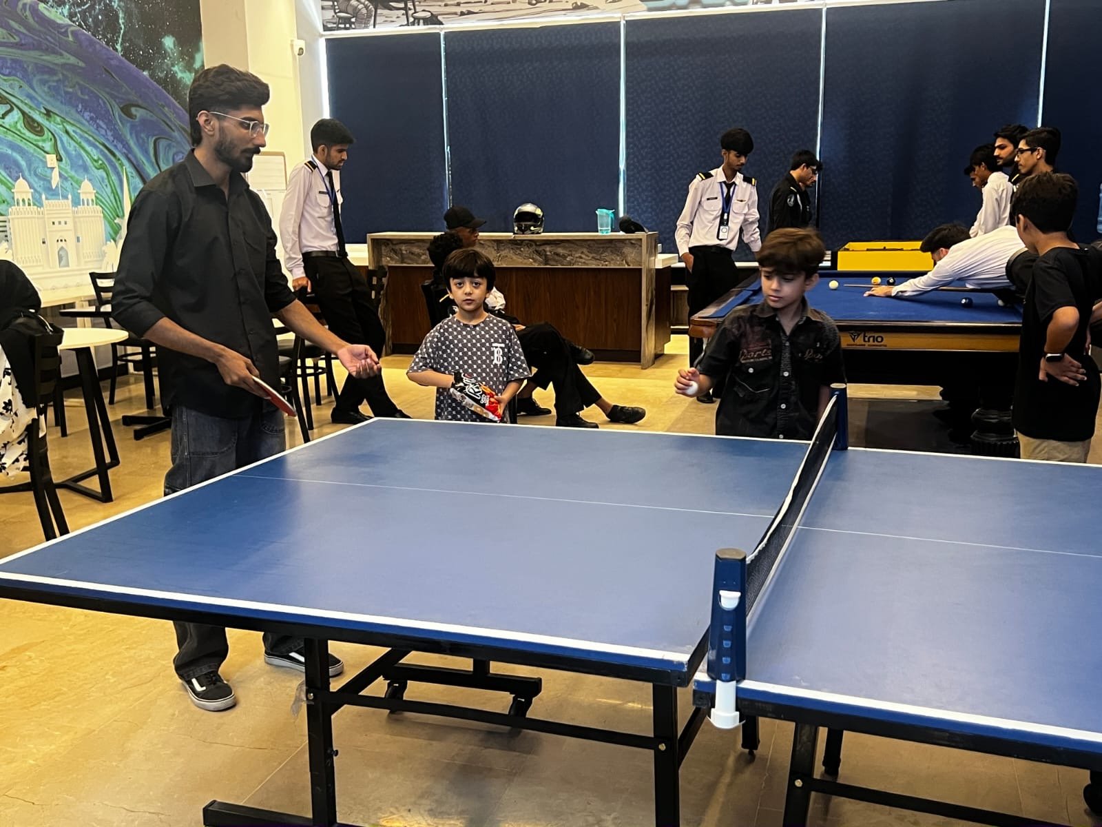 Children playing table tennis during an activity break at the bootcamp