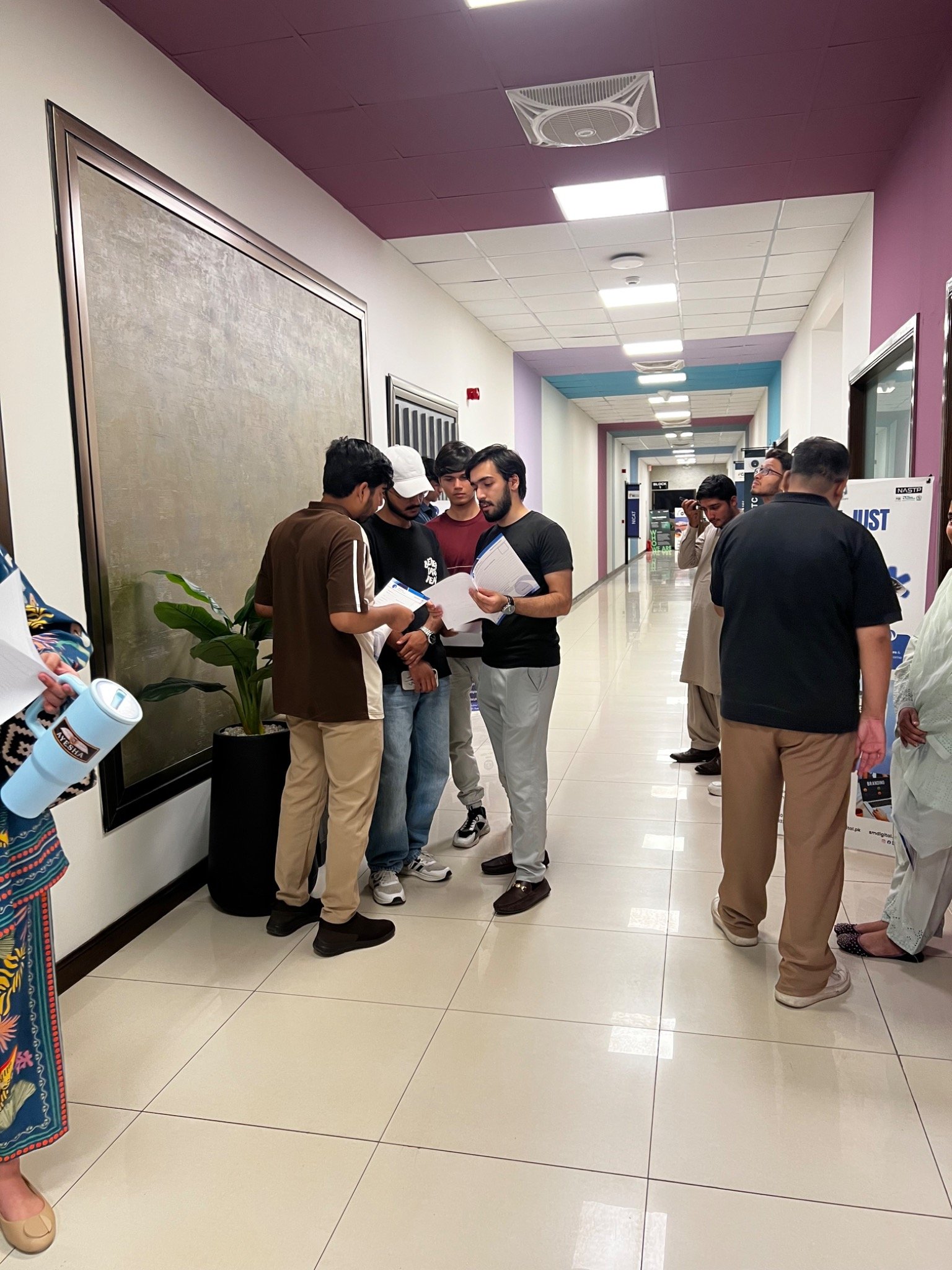 Participants talking and looking at documents outside the session room